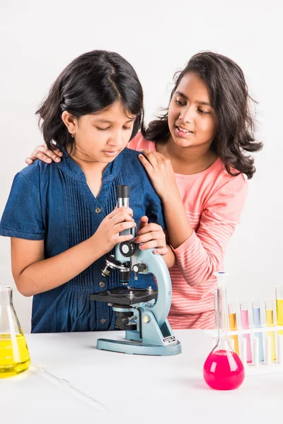 Indian little girls or indian students and science experiments. Education. asian kids and science experiments, chemistry experiment, indian girls and science experiments