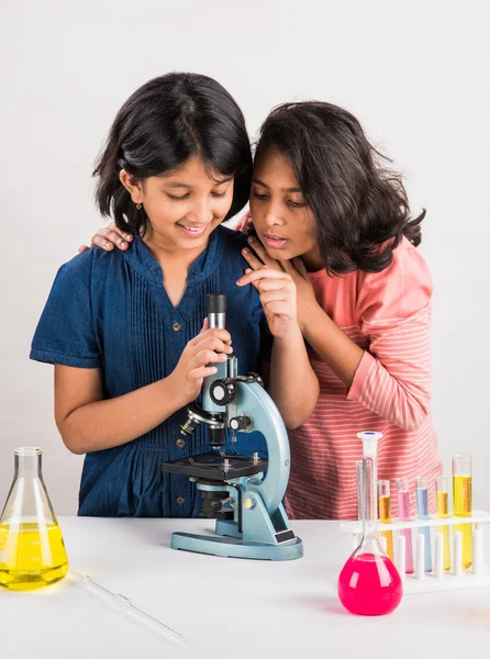 Indian little girls or indian students and science experiments. Education. asian kids and science experiments, chemistry experiment, indian girls and science experiments