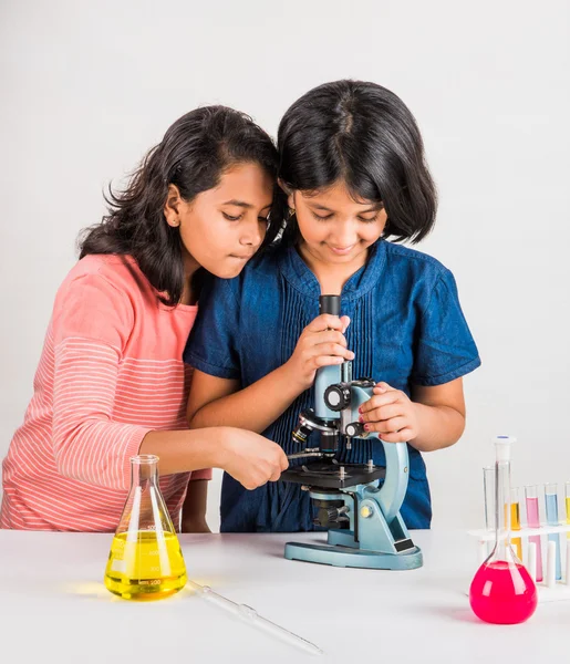 Indian little girls or indian students and science experiments. Education. asian kids and science experiments, chemistry experiment, indian girls and science experiments