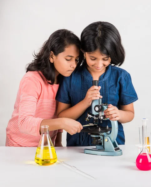 Indian little girls or indian students and science experiments. Education. asian kids and science experiments, chemistry experiment, indian girls and science experiments