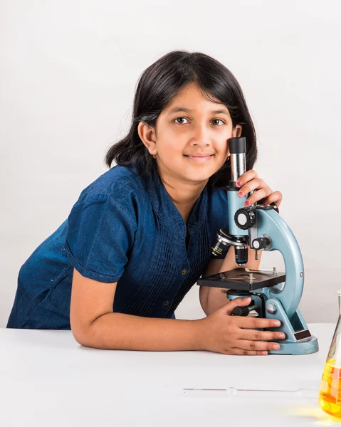 Curious indian girl with microscope, asian girl with microscope, Cute little girl holding microscope, 10 year old indian girl and science experiment, girl doing science experiments, science lab