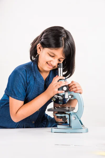 Curious indian girl with microscope, asian girl with microscope, Cute little girl holding microscope, 10 year old indian girl and science experiment, girl doing science experiments, science lab