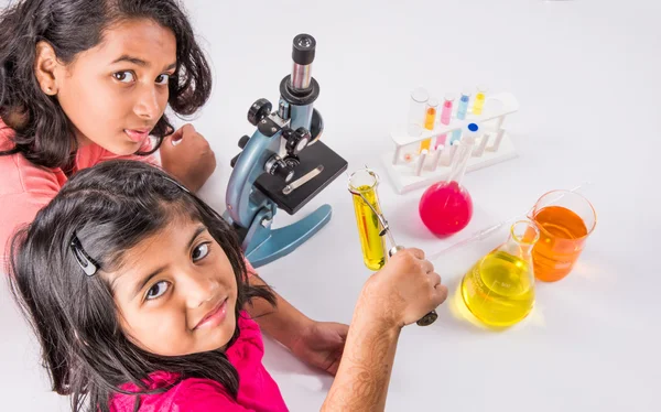 Indian kids doing science experiment, science Education. asian kids and science experiments, chemistry experiment, indian kids and science experiments, indian kids and science lab