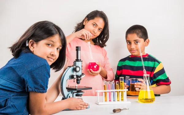 3 indian kids doing science experiment, science Education. asian kids and science experiments, chemistry experiment, indian kids and science experiments, indian kids and science lab