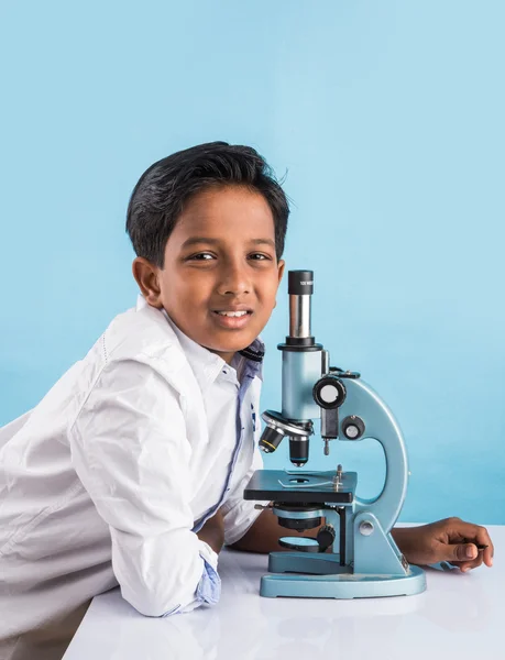 Indian boy and microscope, asian boy with microscope, Cute little kid holding microscope, 10 year old indian boy and science experiment, boy doing science experiments