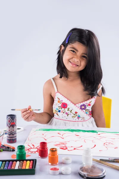 Indian girl colouring or painting, asian girl with paint brush