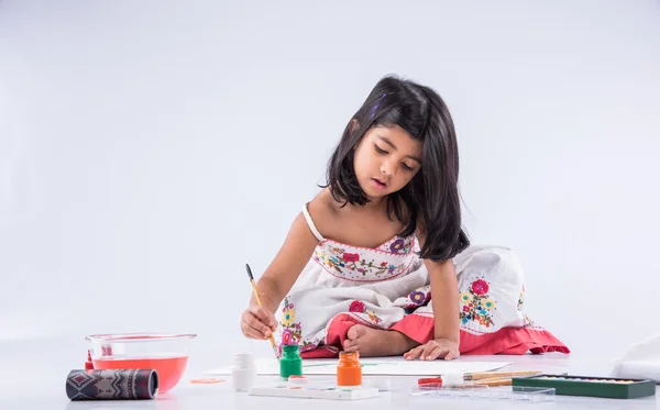 Indian girl colouring or painting, asian girl with paint brush
