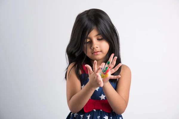 Cute girl showing her colorful hands, surprised. Indian young girl with palm painted, asian girl and palm painting, palm printing