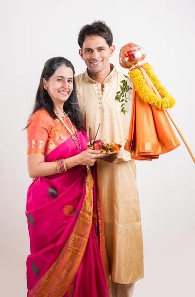 Smart indian couple in traditional wear performing gudhi padwa puja, asian couple & puja thali, indian young couple with puja or pooja thali, hindu new year gudhi / gudi padwa, isolated