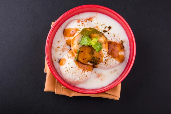 Dahi vada or dahi vade also known as Curd Vadai in South India, a popular snack famous all over India prepared by soaking lentil vadas in thick dahi or yogurt, topped with spicy & sweet chutney etc