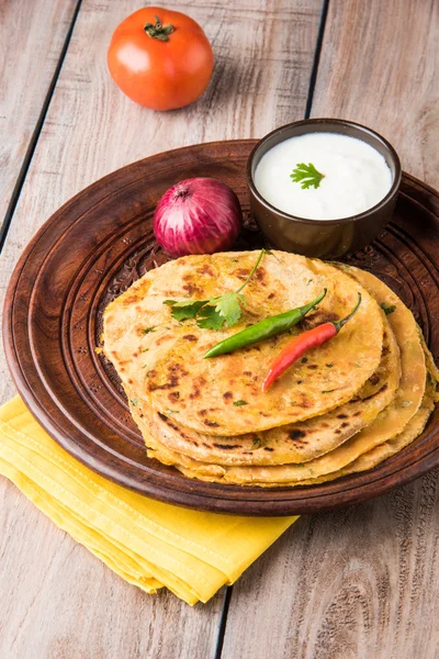Traditional Indian bread - Aloo paratha or aalu parotha, potato stuffed bread. served with tomato ketchup or sauce and curd