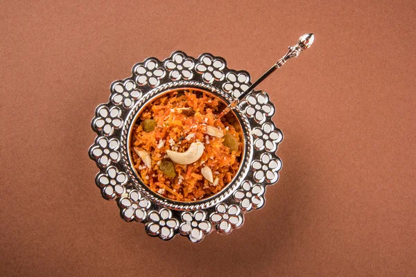 Tasty gajar halwa or gajar ka halwa made up or fresh carrot, sugar and milk. decorated with almond or badam, cashewnuts and pistachios, favourite north indian dessert usually served in weddings