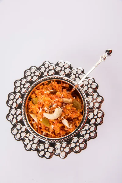 Tasty gajar halwa or gajar ka halwa made up or fresh carrot, sugar and milk. decorated with almond or badam, cashewnuts and pistachios, favourite north indian dessert usually served in weddings