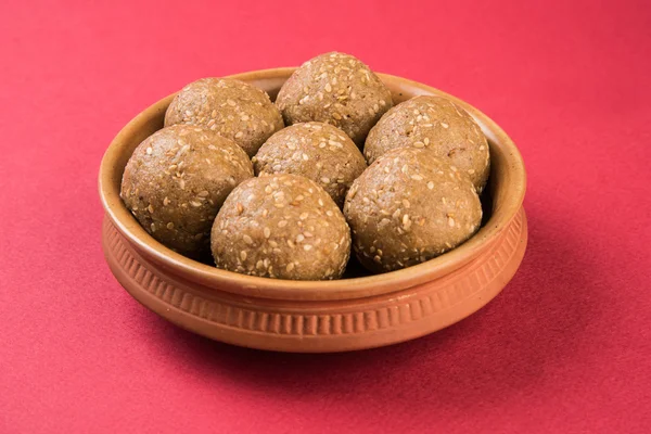 Indian sesame sweet or tilgul laddu, made up of jaggery and sesame seeds, hand made, round, indian sweet prepared in Makar Sankranti festival