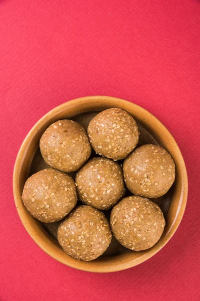 Indian sesame sweet or tilgul laddu, made up of jaggery and sesame seeds, hand made, round, indian sweet prepared in Makar Sankranti festival