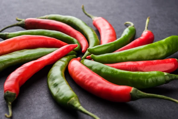 Red and green chilli peppers or fresh chillies forming circle or other shapes