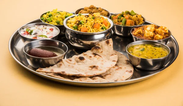 Indian thali, indian food thali, punjabi thali, punjabi food thali, north indian thali, roti, gulab jamum, paneer, chole, pulav or veg biryani, raita or rayta, daal tadka or tarka combination