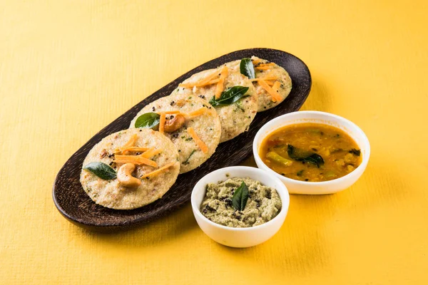 South indian favourite food rava idli or semolina idly or rava idly, served with sambar and green chutney, isolated over white background