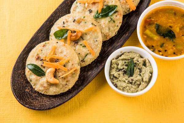 South indian favourite food rava idli or semolina idly or rava idly, served with sambar and green chutney, isolated over white background