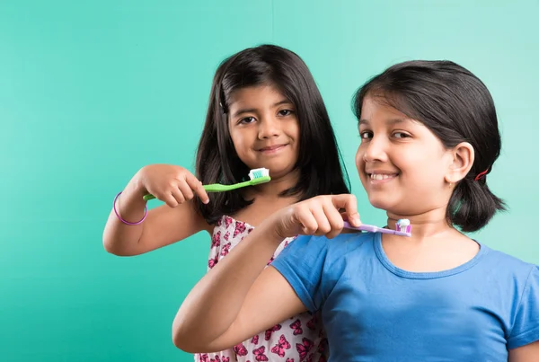 Cute indian girls posing with tooth brush, indian girls and brushing, asian girls with tooth brush & paste, indian girls caring their teeth, indian girls & oral care, indian girls & bed time brushing