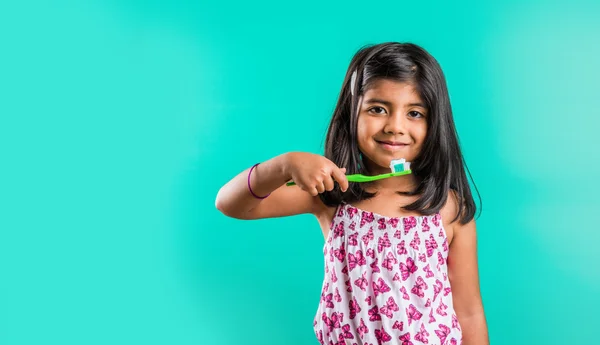 Indian girl and tooth brush, indian girl and brushing, asian girl with tooth brush and paste, indian girl caring her teeth, indian girl and oral care, indian girl and bed time brushing