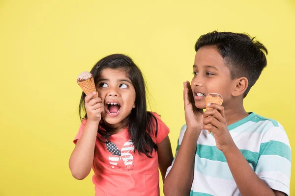 Indian girl and boy and ice cream, indian kids eating ice cream, asian kids and ice cream, isolated on green