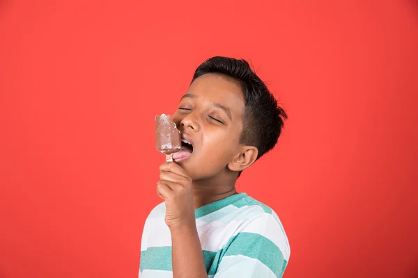 Kid enjoying ice cream, indian boy and ice cream, ice cream and india, 10 year boy eating ice cream, isolated on colourful background