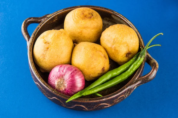 Indian home made snack called batata vada or aalu bonda or aalu bonde servedtomato ketchup