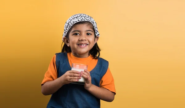 4 year old indian girl with a glass full of plain white milk, indian girl and plain milk, indian girl drinking milk, asian girl and milk glass, portrait, brown skin, indian baby girl