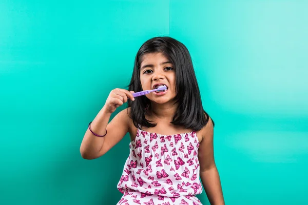 Indian girl and tooth brush, indian girl and brushing, asian girl with tooth brush and paste, indian girl caring her teeth, indian girl and oral care, indian girl and bed time brushing