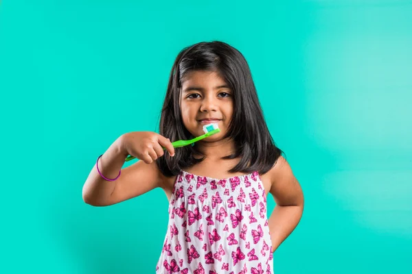 Indian girl and tooth brush, indian girl and brushing, asian girl with tooth brush and paste, indian girl caring her teeth, indian girl and oral care, indian girl and bed time brushing