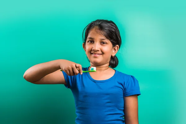 Indian girl and tooth brush, indian girl and brushing, asian girl with tooth brush and paste, indian girl caring her teeth, indian girl and oral care, indian girl and bed time brushing