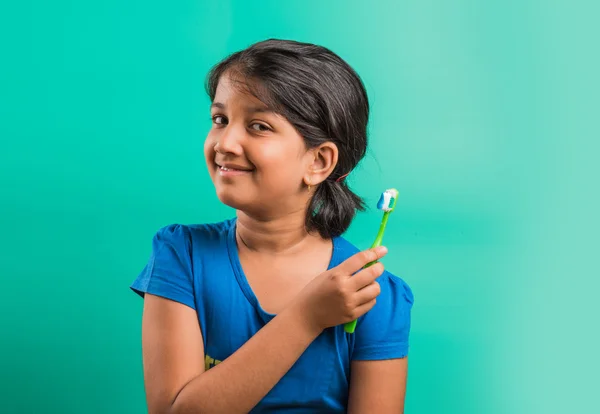 Indian girl and tooth brush, indian girl and brushing, asian girl with tooth brush and paste, indian girl caring her teeth, indian girl and oral care, indian girl and bed time brushing