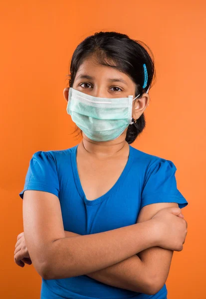 Indian girl wearing face mask, Flu illness child girl in medicine healthcare mask, A Little indian girl with the protective mask, asian girl wearing medical mask, swine flu
