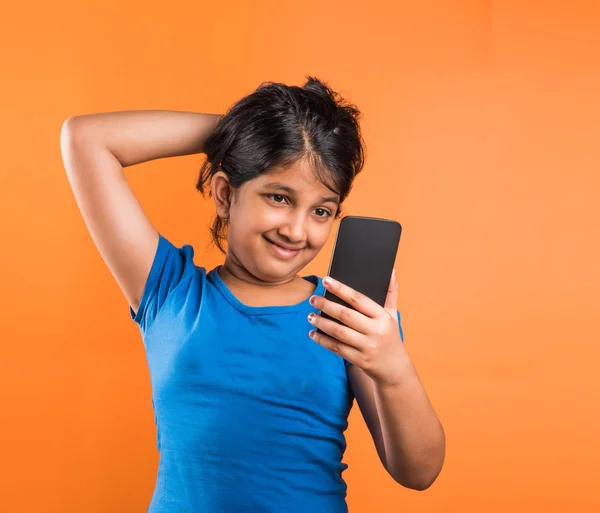 Indian small girl with mobile, asian small girl with mobile, indian girl child and mobile, asian girl clild and mobile, indian small girl posing with mobile, indian girl playing with mobile, selfie
