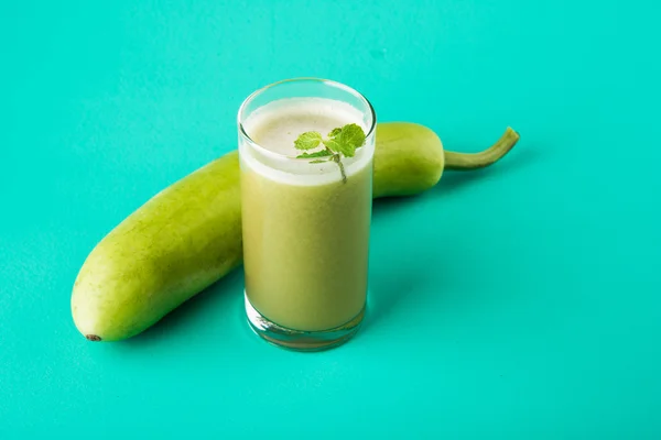 Juice of bottle gourd or lauki juice or Lagenaria siceraria juice, bottle gourd juice, powerful health juice popular in India, isolated over white background