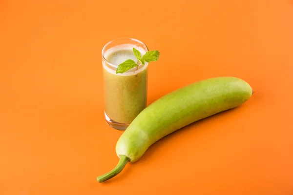 Juice of bottle gourd or lauki juice or Lagenaria siceraria juice, bottle gourd juice, powerful health juice popular in India, isolated over white background