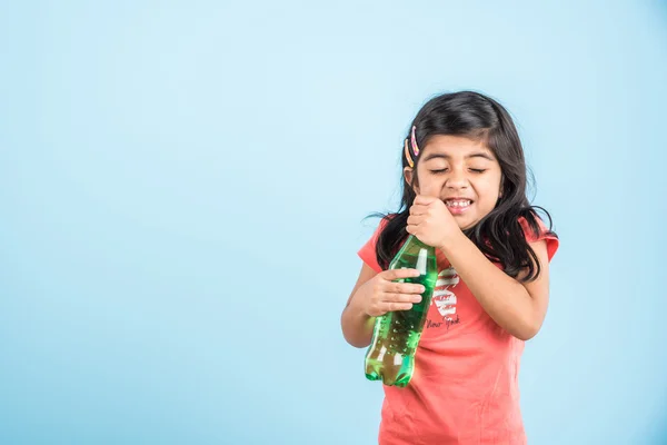 Indian girl with cold drink bottle, asian girl drinking cold drink in pet bottle, girl kid and cold drink, indian cute girl with mango or orange cold drink in plastic bottle, isolated