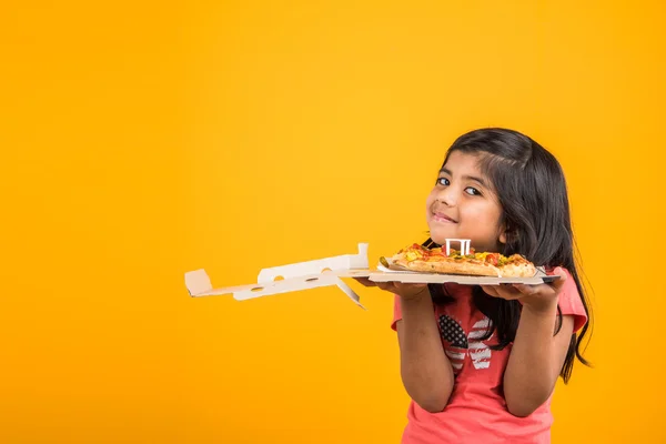 Portrait of cute indian girl holding an open box of pizza, excited asian girl opening pizza box showing smile on face, standing over yellow background