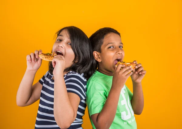 Indian boy and girl eating pizza, asian kids eating pizza