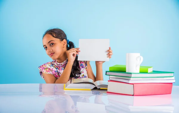 Indian girl student holding white board while studying, indian girl studying and holding white card with copy space, asian girl holding white card and studying
