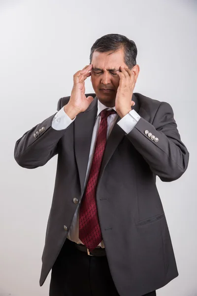 Indian businessman and headache, frustrated indian businessman, asian businessman and frustration, isolated over white background