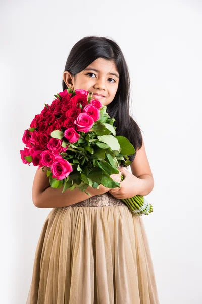 Indian little girl holding bouquet or red rose flowers, asian girl with flowers, little indian girl with bunch of red roses