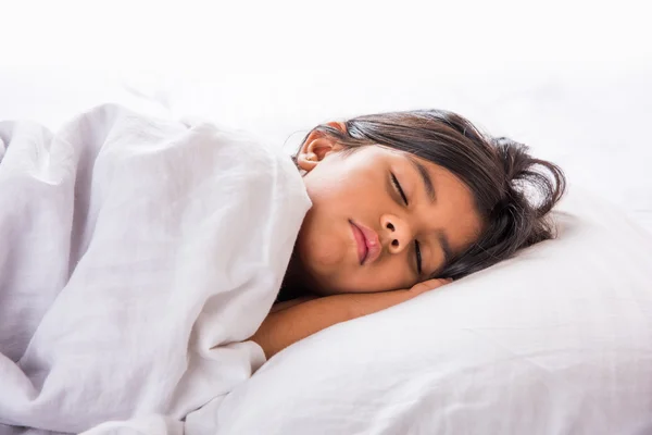 Cute Indian Girl sleeping over white pillow, small asian girl sleeping on bed