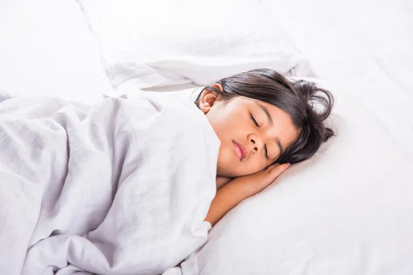 Cute Indian Girl sleeping over white pillow, small asian girl sleeping on bed