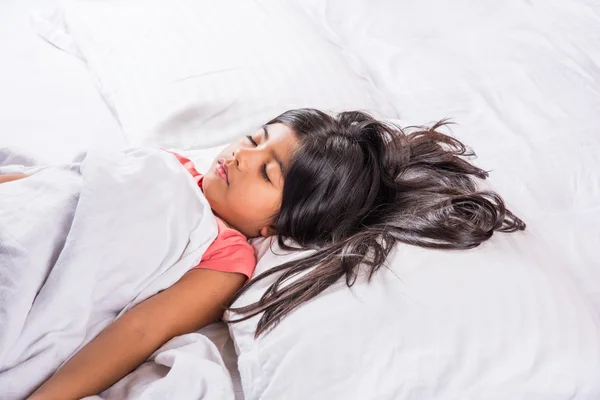 Cute Indian Girl sleeping over white pillow, small asian girl sleeping on bed