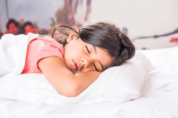 Cute Indian Girl sleeping over white pillow, small asian girl sleeping on bed