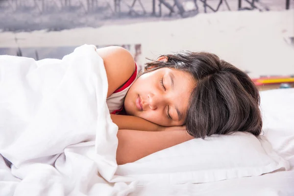 Cute Indian Girl sleeping over white pillow, small asian girl sleeping on bed