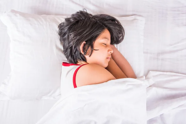 Cute Indian Girl sleeping over white pillow, small asian girl sleeping on bed