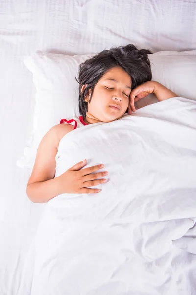 Cute Indian Girl sleeping over white pillow, small asian girl sleeping on bed